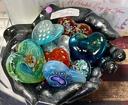 Resin hand bowl with pocket hugs hearts.